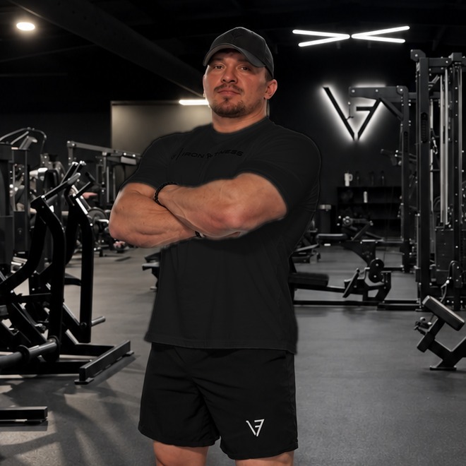 Patrick Neumiller, arms crossed, in his gym
